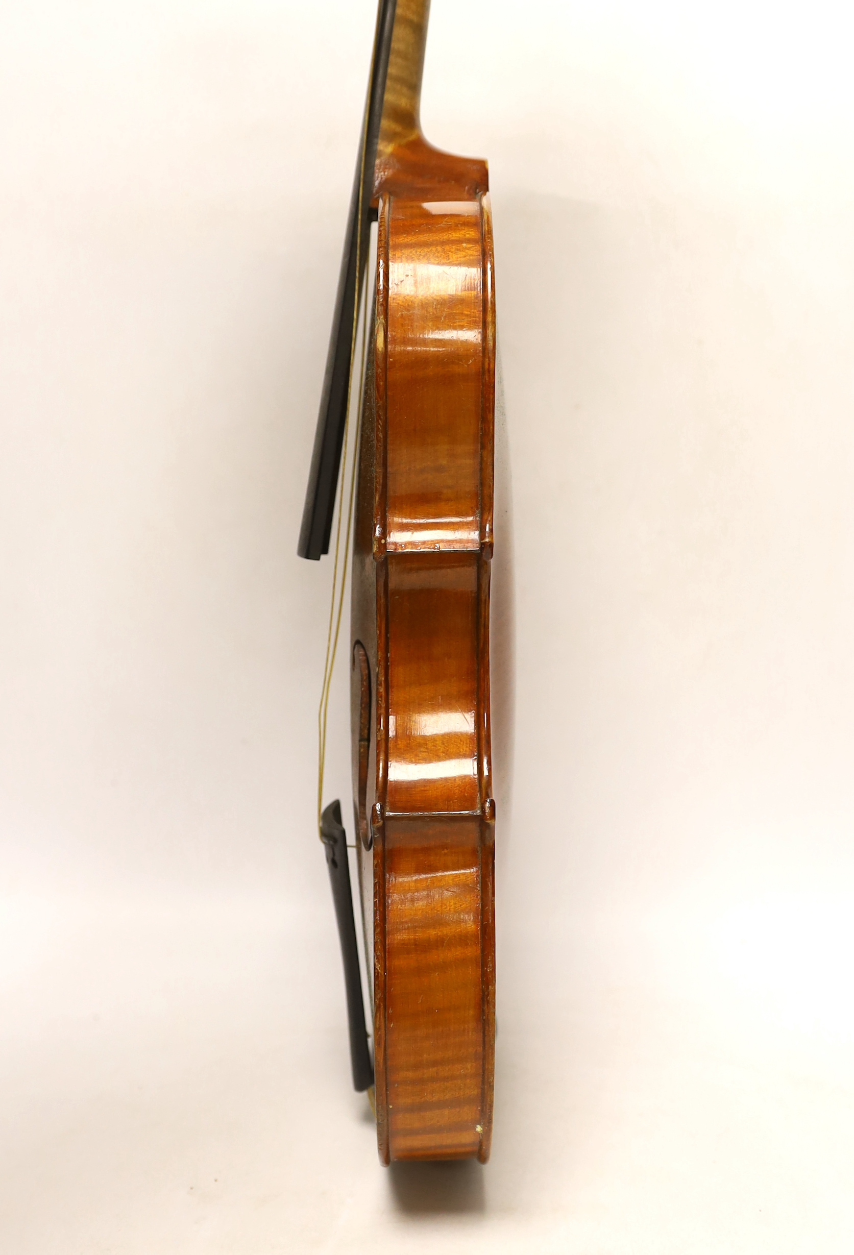 An early 20th century cased violin, length of the back 36cm